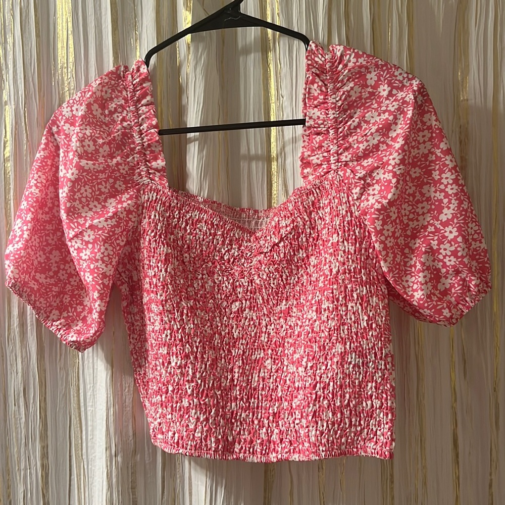 Cropped pink floral shirt has puffy sleeves